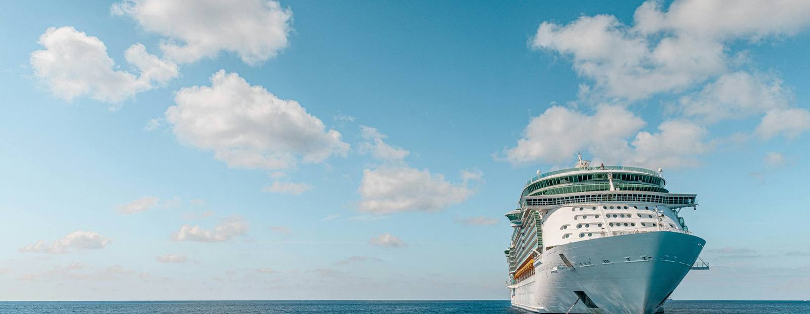 A cruise ship at sea under an open sky